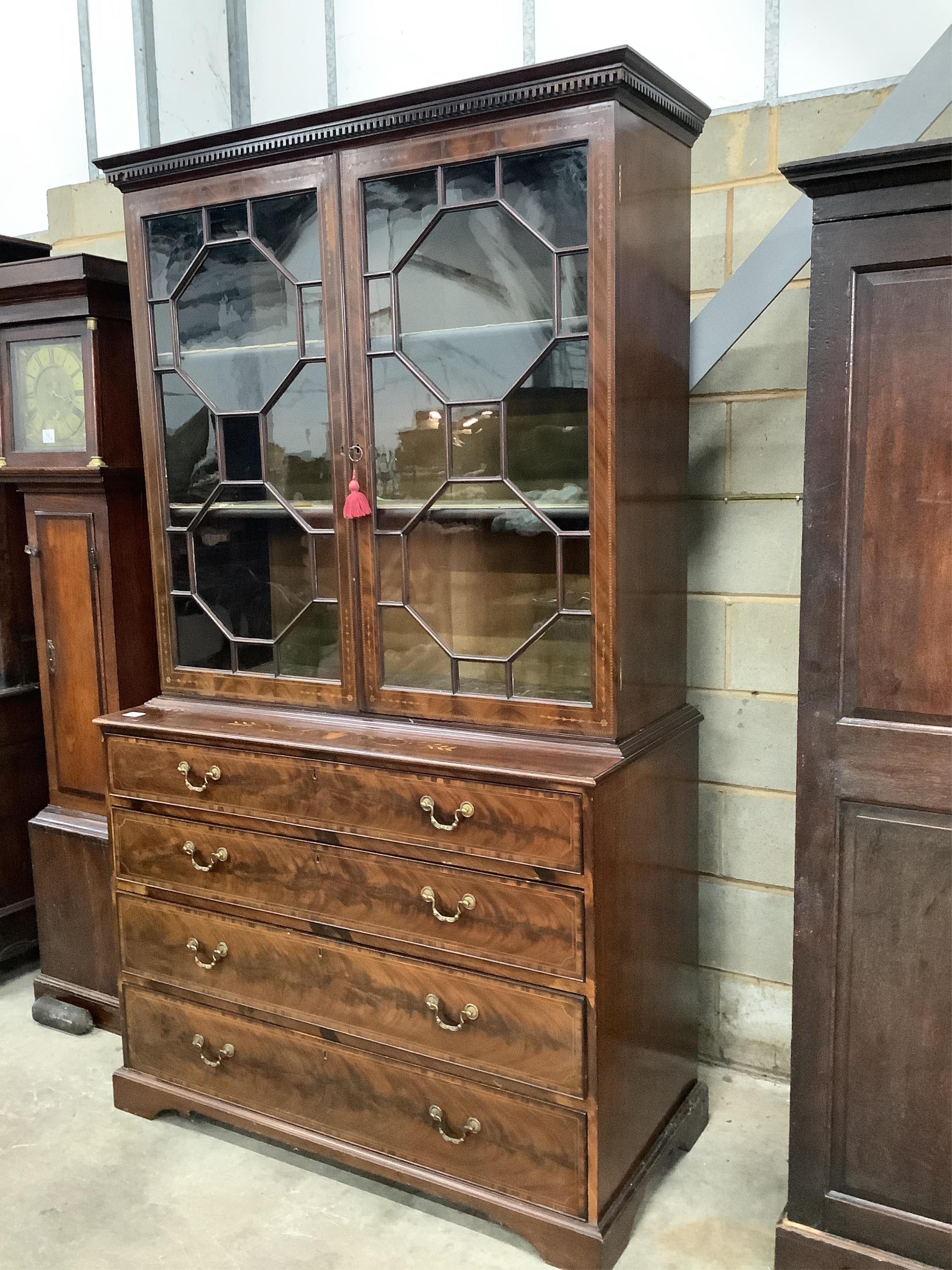 A late Victorian Sheraton Revival inlaid mahogany bookcase retailed by S & H Jewell, width 125cm, height 217cm. Condition - good